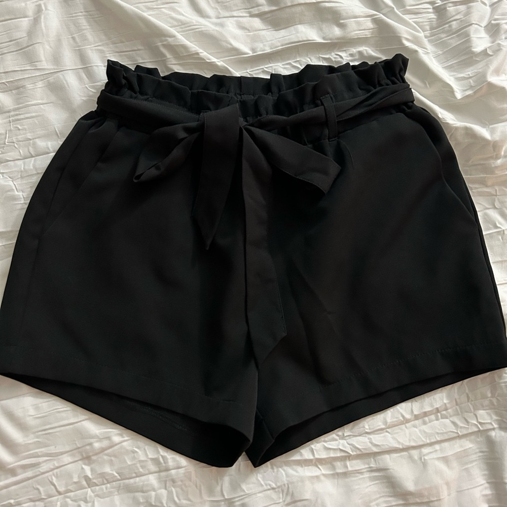 Black, size medium tie waist paper bag shorts.